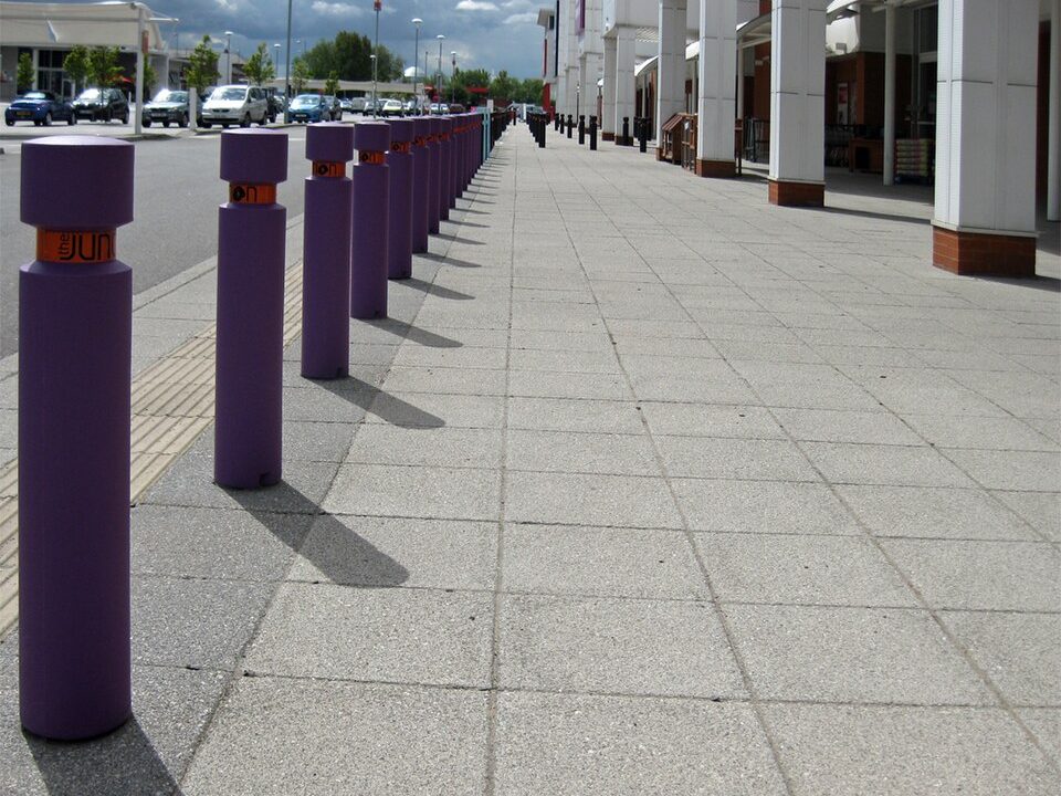 Row of steel security bollards along a retail frontage