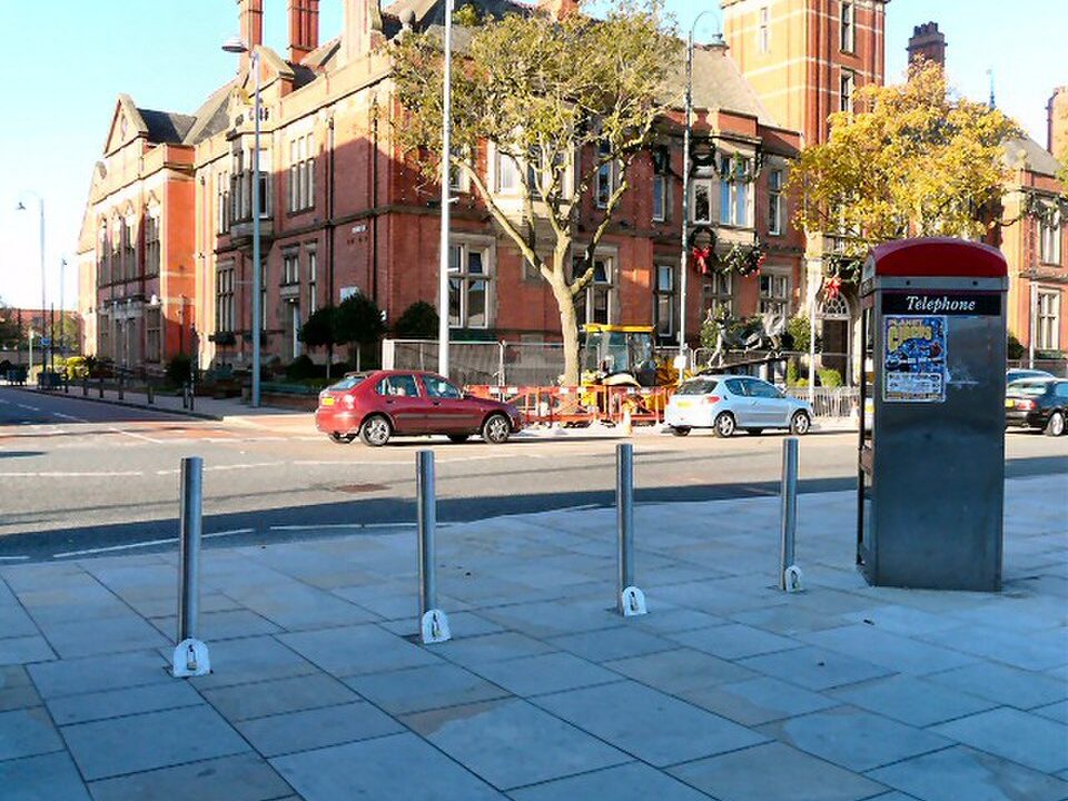 Retractable steel bollards set into paving